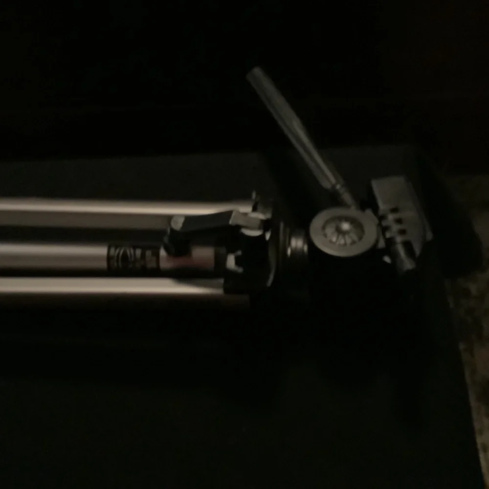 Camera tripod, adjustable.